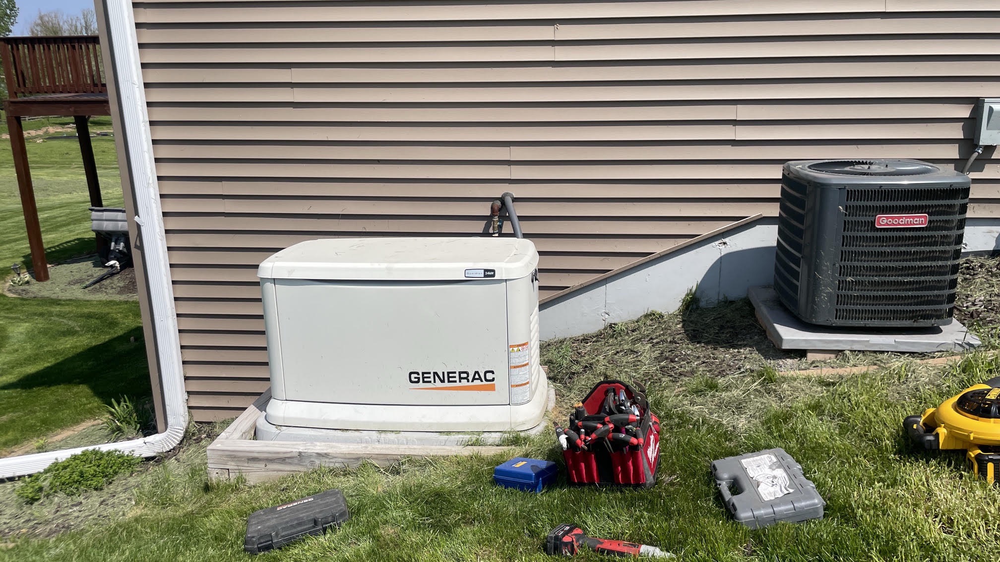 Generac Guardian 24kW standby generator installed beside a home with tools laid out during the install