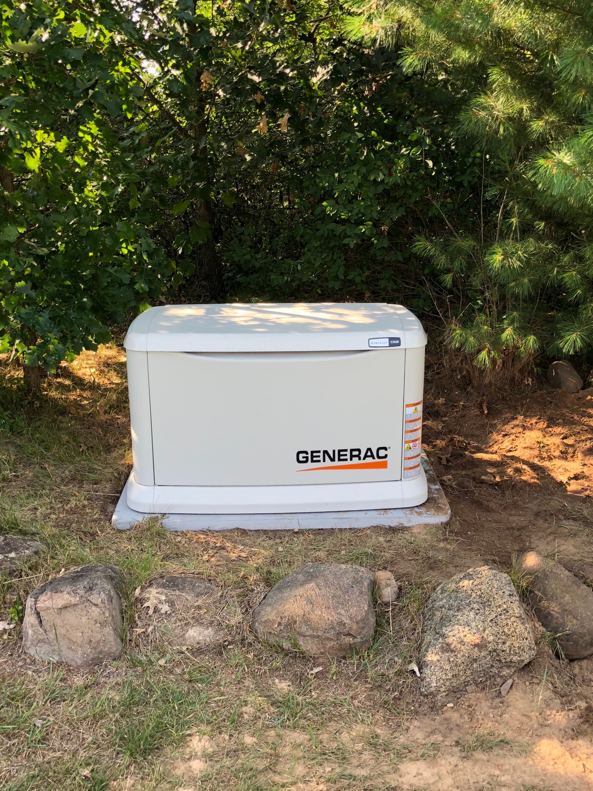 Generac Guardian standby generator installed on a wooded rural property